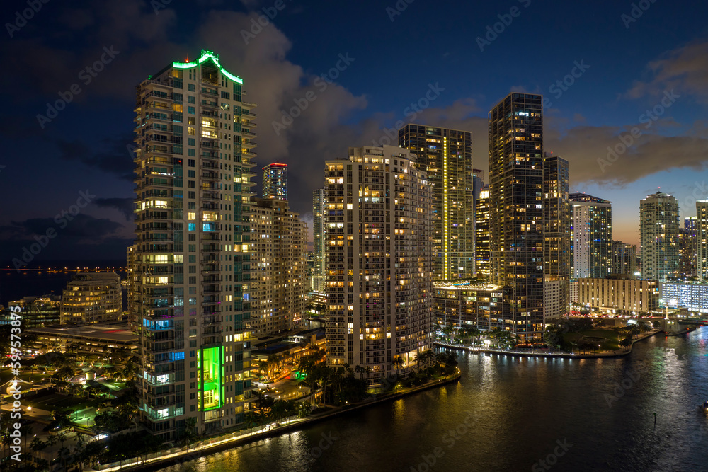 View from above of brightly illuminated high skyscraper buildings in downtown district of Miami Brickell in Florida, USA. American megapolis with business financial district at night View from above of brightly illuminated high skyscraper buildings in downtown district of Miami Brickell in Florida, USA. American megapolis with business financial district at night
