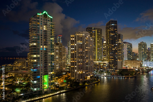 View from above of brightly illuminated high skyscraper buildings in downtown district of Miami Brickell in Florida  USA. American megapolis with business financial district at night