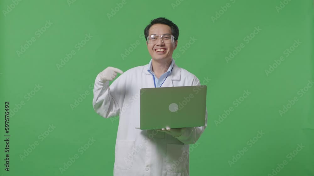 Asian Man Scientist Smiling And Pointing To A Laptop While Standing On The Green Screen Background In The Laboratory
Asian Man Scientist Smiling And Pointing To A Laptop While Standing On The Green Screen Background In The Laboratory