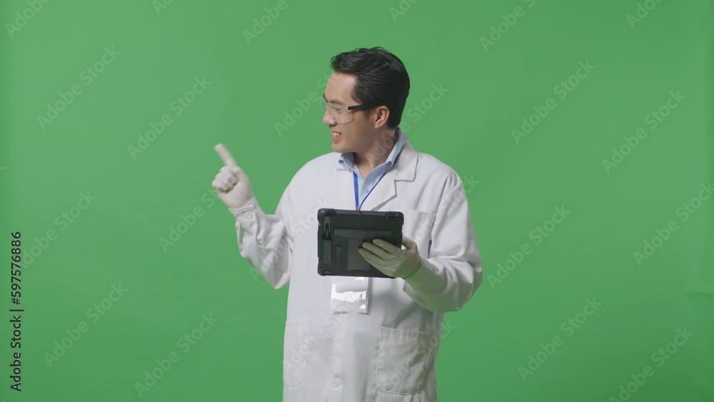 Asian Man Scientist With A Tablet Smiling And Pointing To Side While Standing On The Green Screen Background In The Laboratory
Asian Man Scientist With A Tablet Smiling And Pointing To Side While Standing On The Green Screen Background In The Laboratory