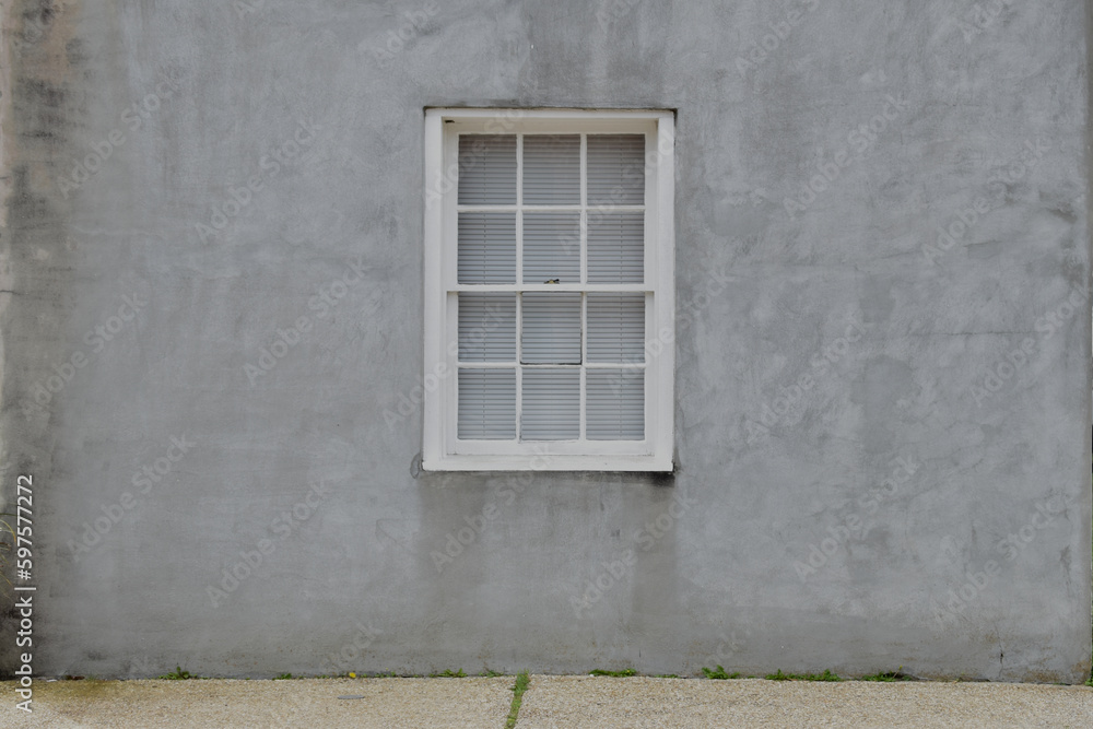 Wood framed window gray stucco wall background