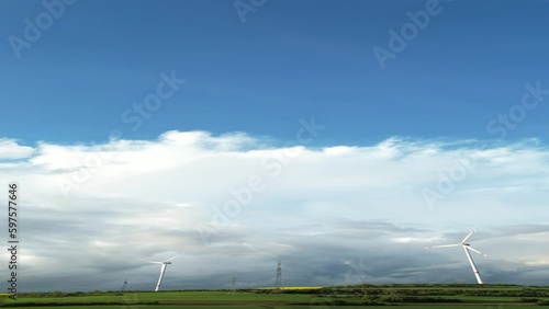 Aerial View of of windmill on agricultural land at cloudy day
