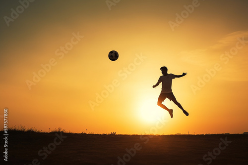 atleta de futebol de silhueta chutando bola no ar