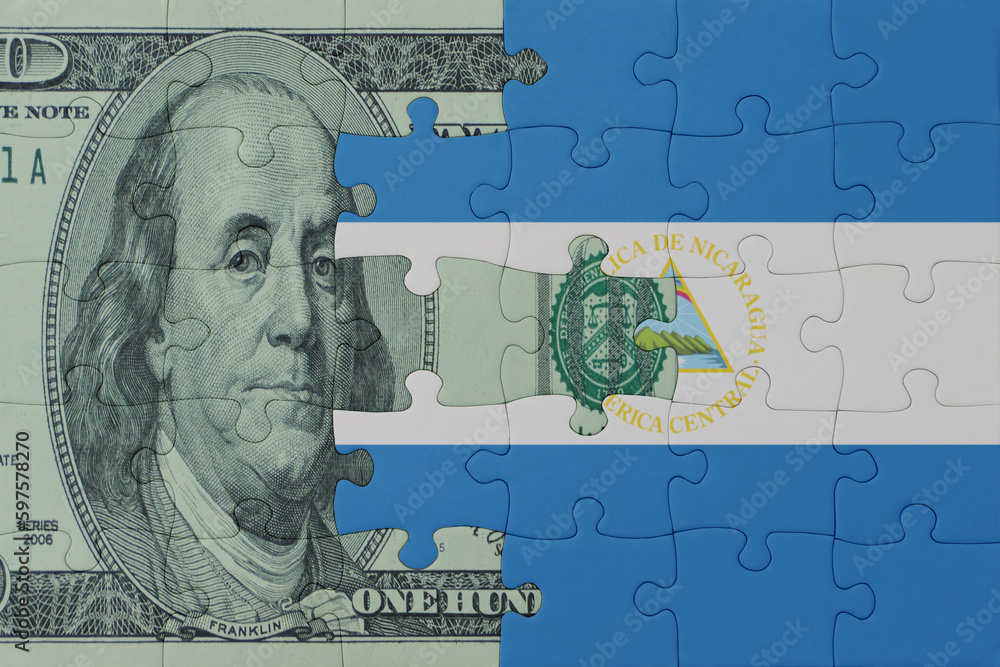 puzzle with the national flag of nicaragua and dollar money banknote. macro.concept.