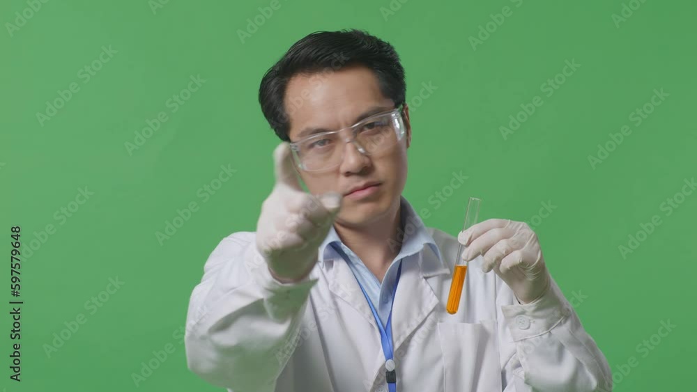 Close Up Of Asian Man Scientist With Orange Liquid In The Test Tube ...