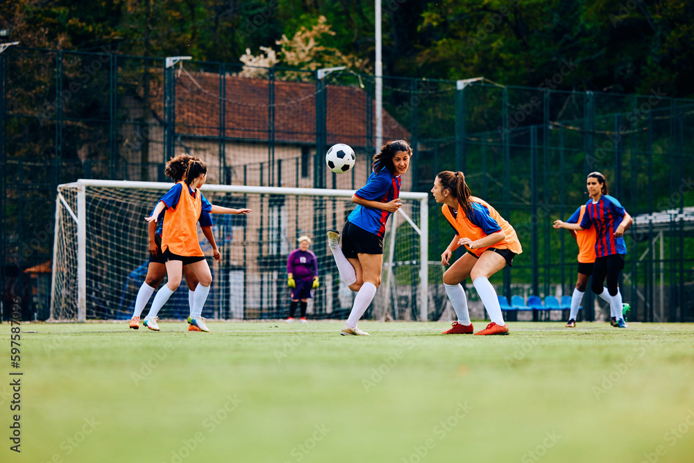Obraz premium Young female players during soccer training at stadium.