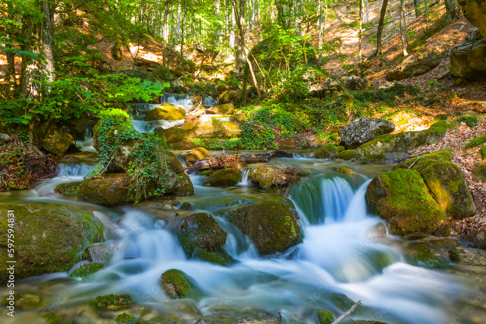 small waterfall on mountain river