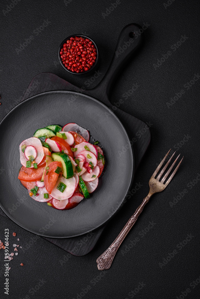 Delicious vegan salad of fresh vegetables of tomatoes, cucumbers and radishes Delicious vegan salad of fresh vegetables of tomatoes, cucumbers and radishes