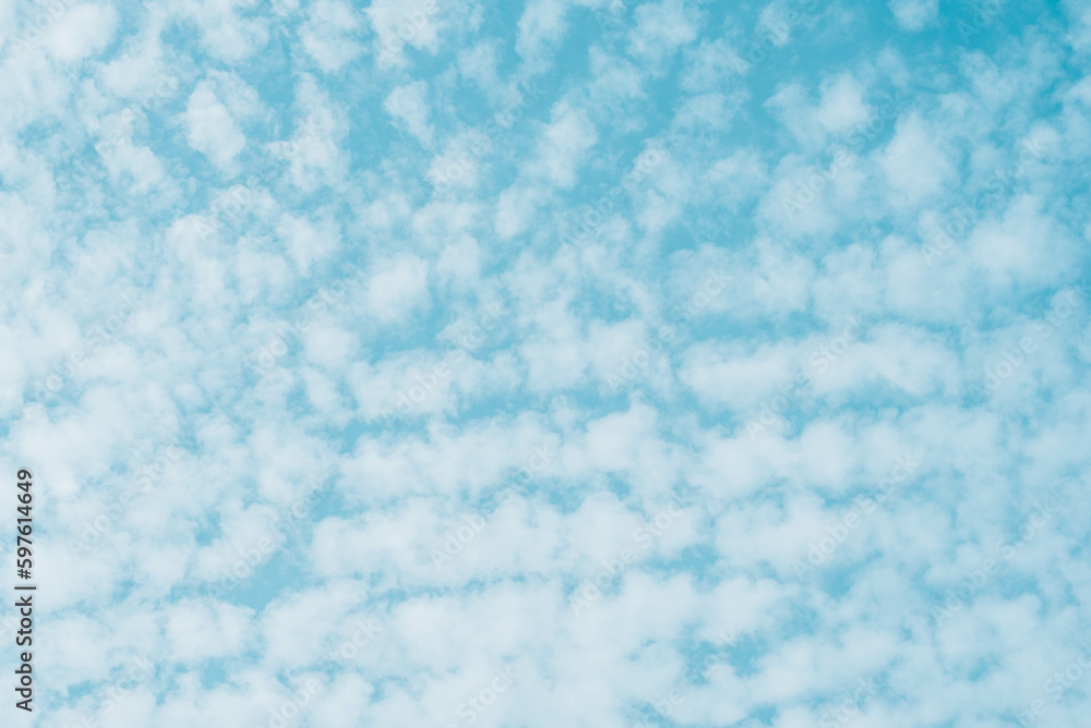 Blue skies with white clouds background with space for text, blue cloudy skies texture. 