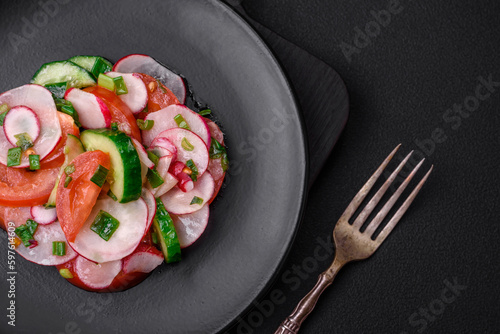 Delicious vegan salad of fresh vegetables of tomatoes, cucumbers and radishes