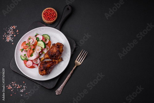 Delicious nutritious dish consisting of grilled chicken legs with a salad