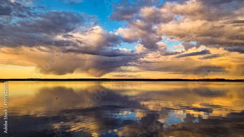 beach sunset, colorful cloudy twilight sky reflecting on the ocean