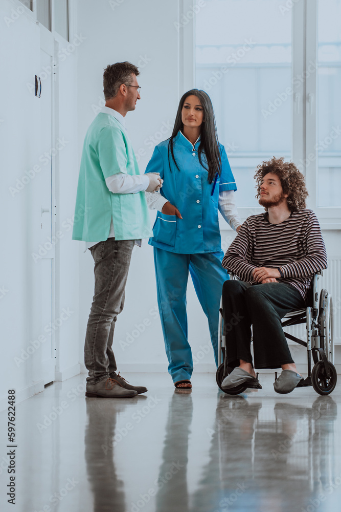 Fototapeta premium Doctor and a nurse discussing a patient's health while the patient, who is in a wheelchair, is present beside them.