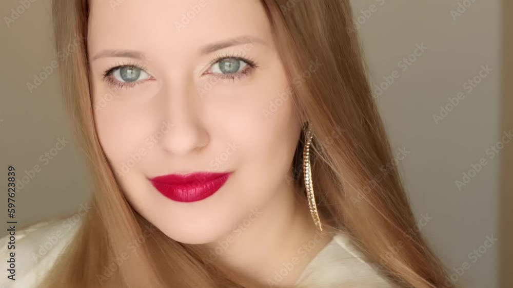 Happy woman smiling with perfect white teeth smile and posing in close-up portrait, female model with long hair wearing golden earrings and red lipstick make-up, jewellery fashion and beauty. Happy woman smiling with perfect white teeth smile and posing in close-up portrait, female model with long hair wearing golden earrings and red lipstick make-up, jewellery fashion and beauty.