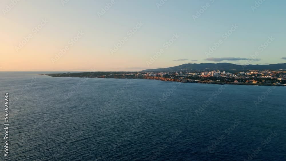 Serene sea evening seaside town. Picturesque aerial ocean coast with resort city Serene sea evening seaside town. Picturesque aerial ocean coast with resort city