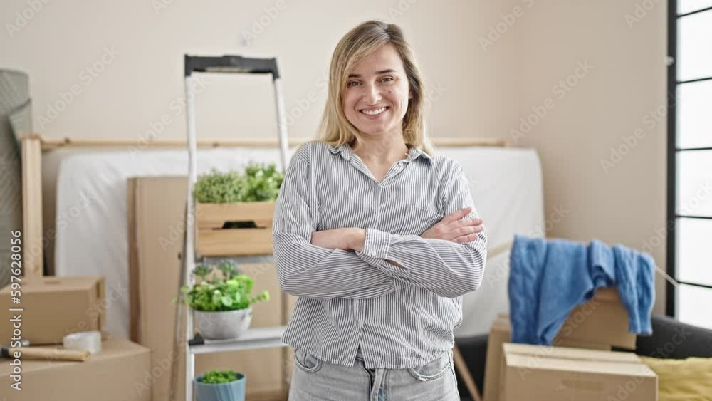 Young blonde woman smiling confident standing with arms crossed gesture at new home Young blonde woman smiling confident standing with arms crossed gesture at new home