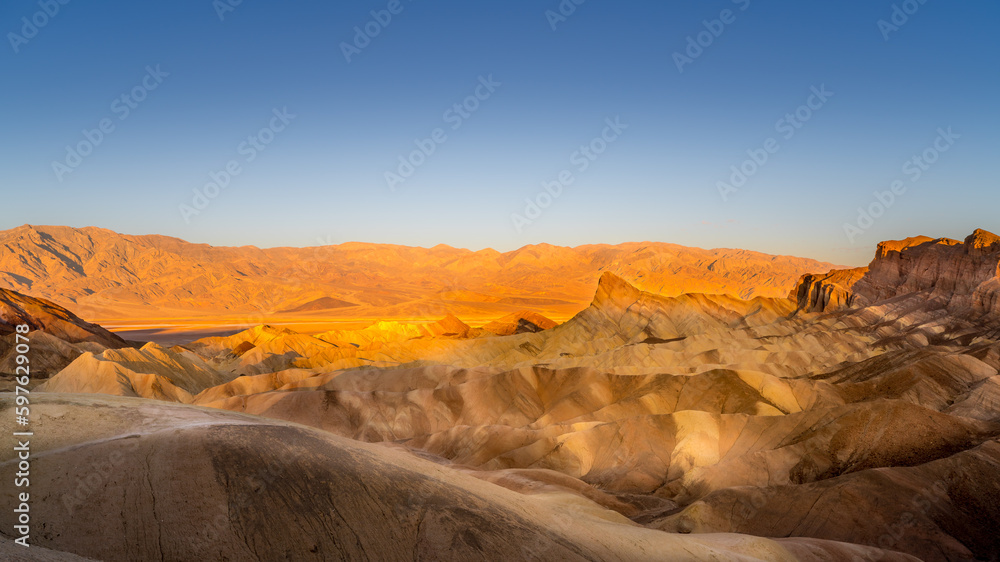 Sunrise over the borax rich badland hills at Zabriskie Point in Death Valley National Park in California, USA