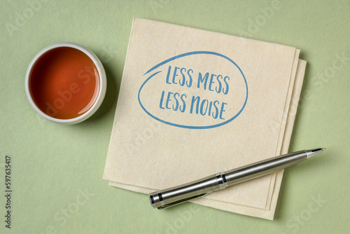 less mess, less noise - inspirational note on a napkin, decluttering, simplicity and minimalism concept