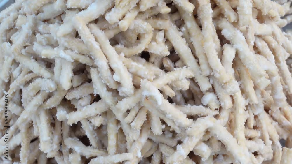 Kathi Goja, Handmade sweet crunchy snack food. Locally called misti nimki. Bangla Pohela Baishakh fair's traditional food. Kathi Goja, Handmade sweet crunchy snack food. Locally called misti nimki. Bangla Pohela Baishakh fair's traditional food.