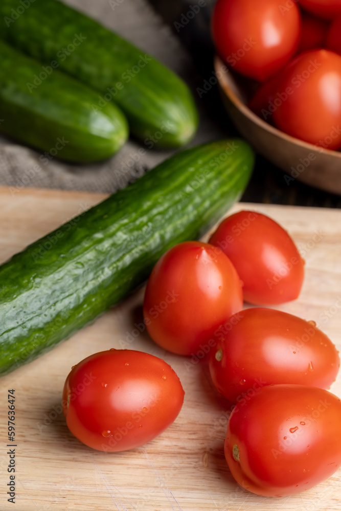 Ripe red fresh tomatoes on a board