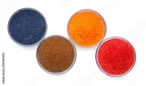 Glass bowls with different food coloring isolated on white, top view