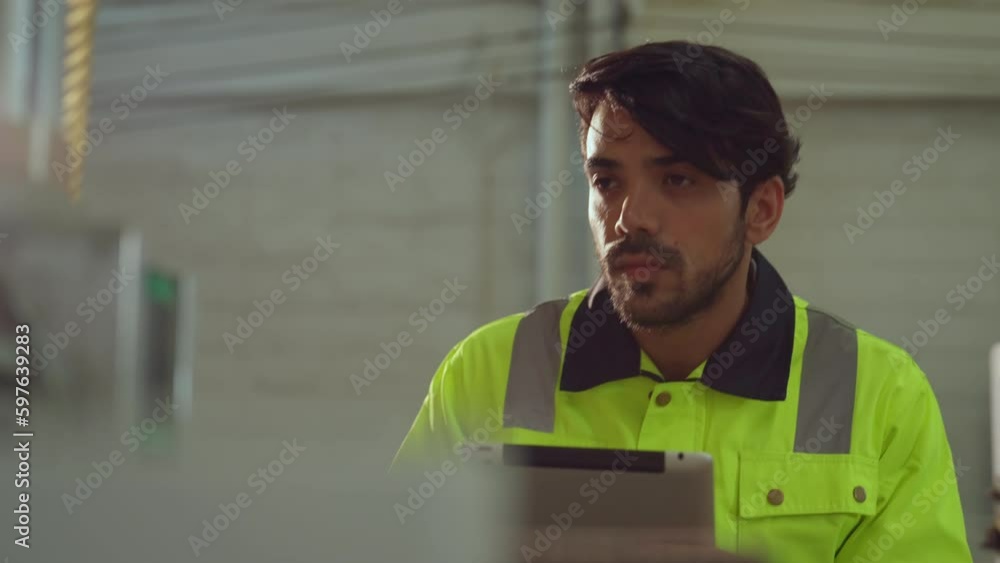 The engineer working at modern manufacturing factory. He checking and control machine in factory. The engineer working at modern manufacturing factory. He checking and control machine in factory.
