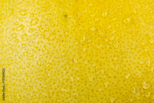 fresh yellow pomelo with water drops on the peel