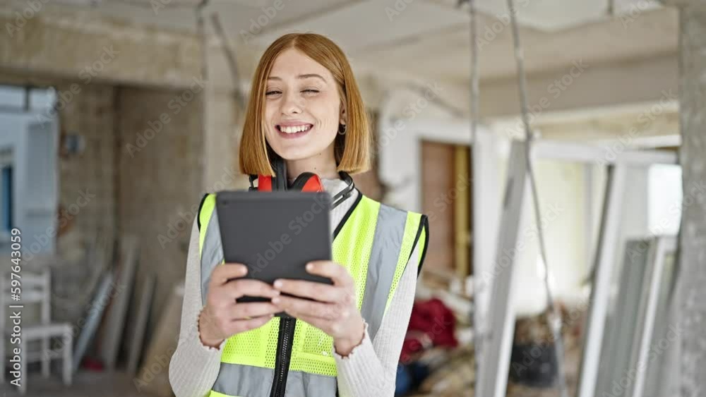 Young blonde woman architect smiling confident using touchpad at construction site Young blonde woman architect smiling confident using touchpad at construction site