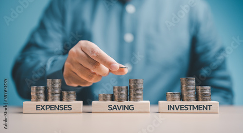 Businessman hand stacking coins. Plan and future financial account management idea. Income Management Concepts for Expenses, Saving and Investment. Important to consider in your prospective planning. photo