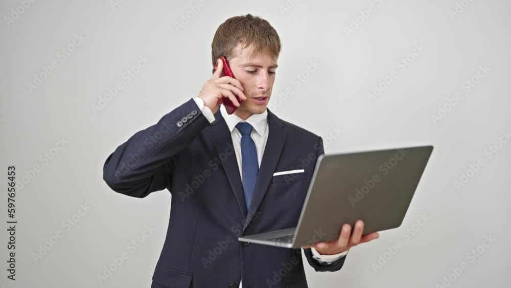 Young caucasian man business worker using laptop talking on smartphone over isolated white background Young caucasian man business worker using laptop talking on smartphone over isolated white background