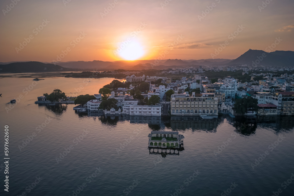 Aerial view of Udaipur city during sunset, known for its beautiful lakes, palaces, and historical significance. The city was founded in 1559.