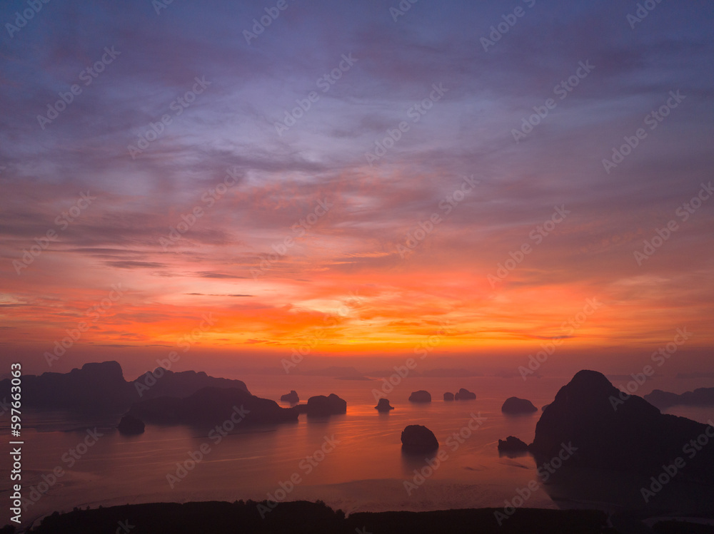 aerial view Amazing light of nature cloudscape sky above Samed Nang Chee Phang Nga archipelago. .Imagine a fantasy bright red sky at sunrise from a bird's eye view..tropical landscape background.