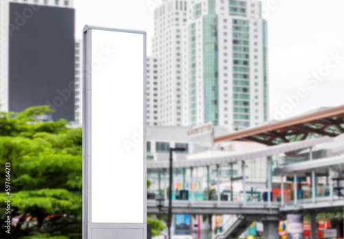 Mock up white LED display vertical billboard on tower pole with cityscape view. clipping path for mockup © Ratchapon
