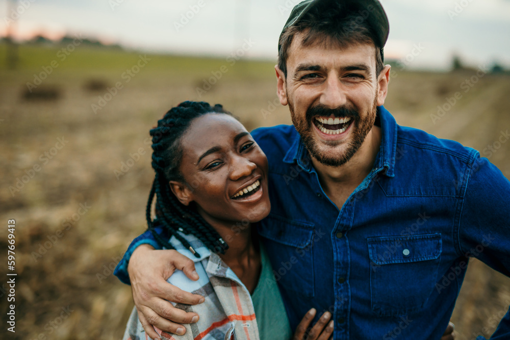 Close up portrait of a diverse couple looking and smiling towards the camera while spending a day outdoors. Lifestyle concept Close up portrait of a diverse couple looking and smiling towards the camera while spending a day outdoors. Lifestyle concept