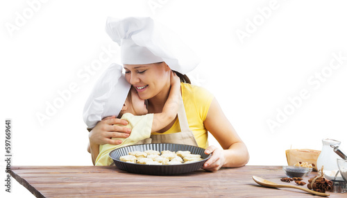 The beautiful young mother and her little daughter cooking