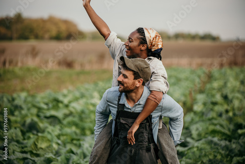 Romantic countryside couple having fun during a workday in the farm field. © La Famiglia
