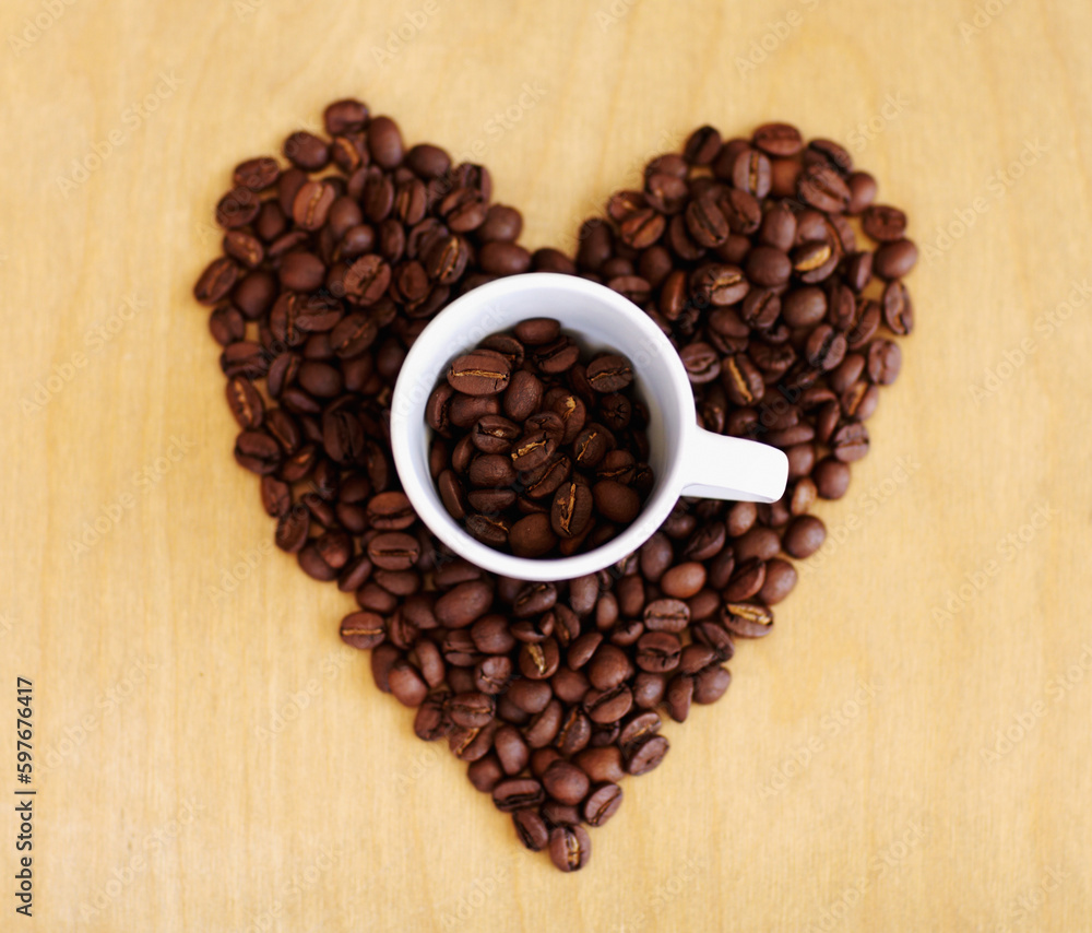 Heart, roasted coffee beans and cafe industry with love icon or emoji for marketing and advertising. Above wooden table or background with grain shape as drink, espresso or caffeine ingredient Heart, roasted coffee beans and cafe industry with love icon or emoji for marketing and advertising. Above wooden table or background with grain shape as drink, espresso or caffeine ingredient