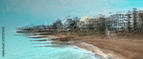Multi exposure image of Eastbourne seafront showing beach, sea, and buildings.