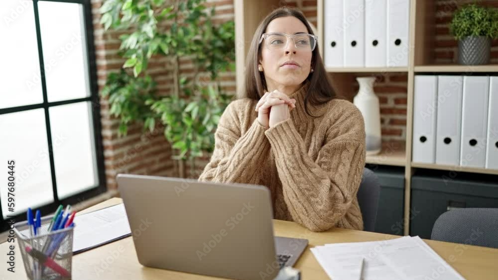Young beautiful hispanic woman business worker using laptop with doubt expression at office Young beautiful hispanic woman business worker using laptop with doubt expression at office