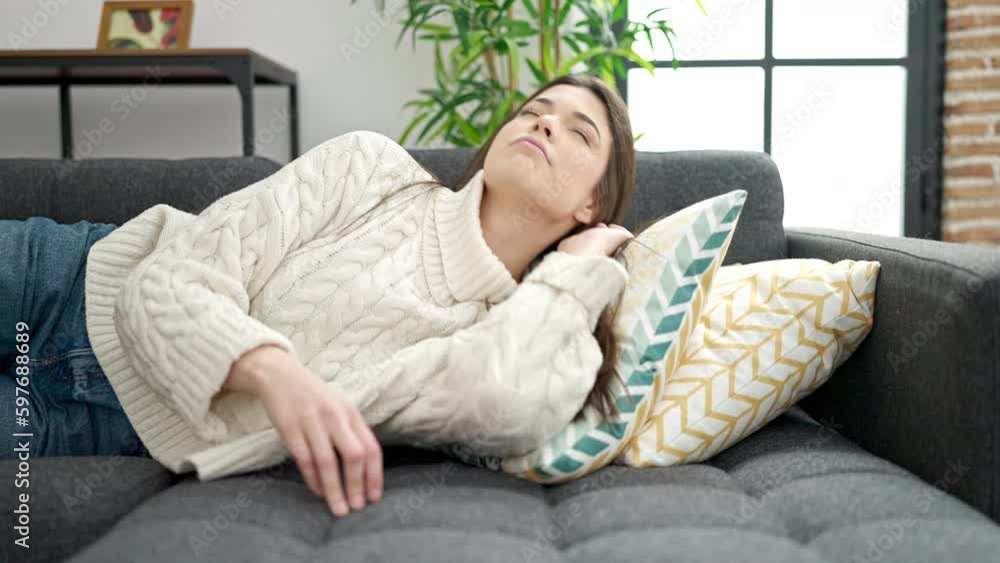 Young beautiful hispanic woman lying on sofa sleeping at home Young beautiful hispanic woman lying on sofa sleeping at home