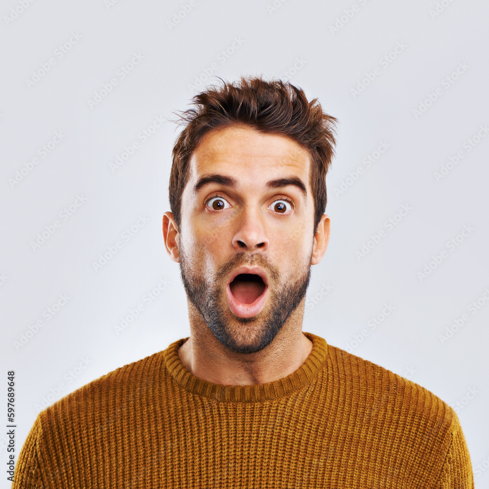 Shock, surprise and portrait of a man in a studio with an amazed facial expression or attitude. Shocked, amazing news and male model with a wtf, omg or wow face gesture isolated. by white background. Shock, surprise and portrait of a man in a studio with an amazed facial expression or attitude. Shocked, amazing news and male model with a wtf, omg or wow face gesture isolated. by white background.