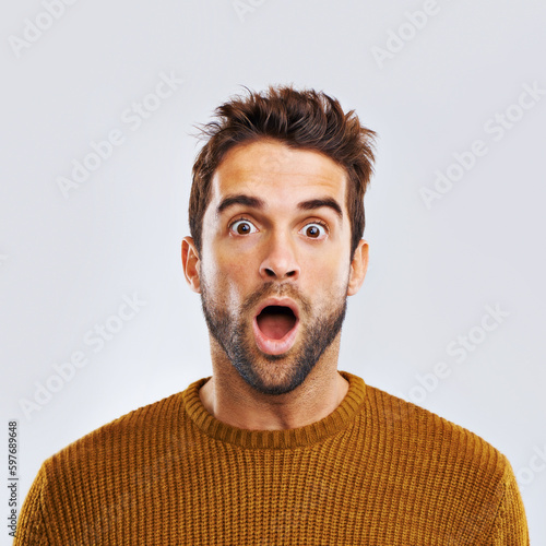 Shock, surprise and portrait of a man in a studio with an amazed facial expression or attitude. Shocked, amazing news and male model with a wtf, omg or wow face gesture isolated. by white background.