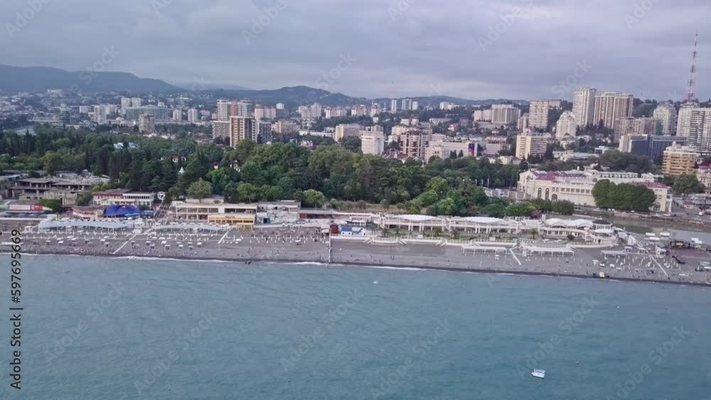 Descending aerial view over beach Pavilion in Sochi, Russia. Flight view next to the Morport in Sochi city and the beautiful residential area landscape on the coastline. Descending aerial view over beach Pavilion in Sochi, Russia. Flight view next to the Morport in Sochi city and the beautiful residential area landscape on the coastline.