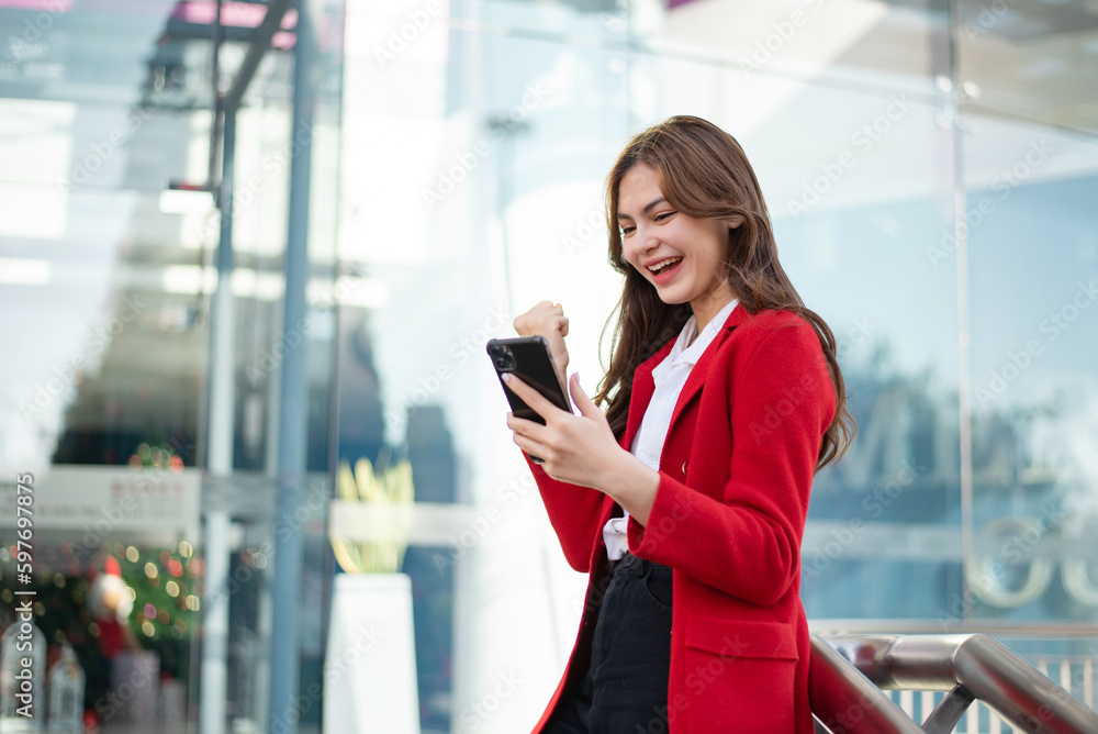 Confident Asian woman with a smile standing holding notepad and tablet at the outside office. Confident Asian woman with a smile standing holding notepad and tablet at the outside office.