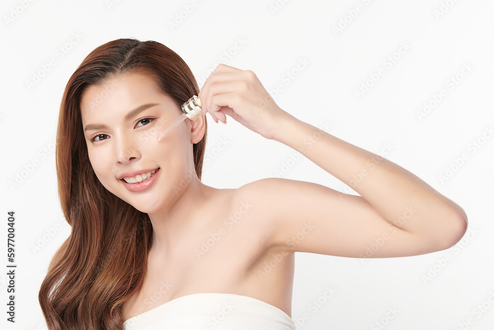Beautiful young asian woman apply facial serum on white background, Skin care and rejuvenation, Face care, Facial treatment, Cosmetology, beauty,