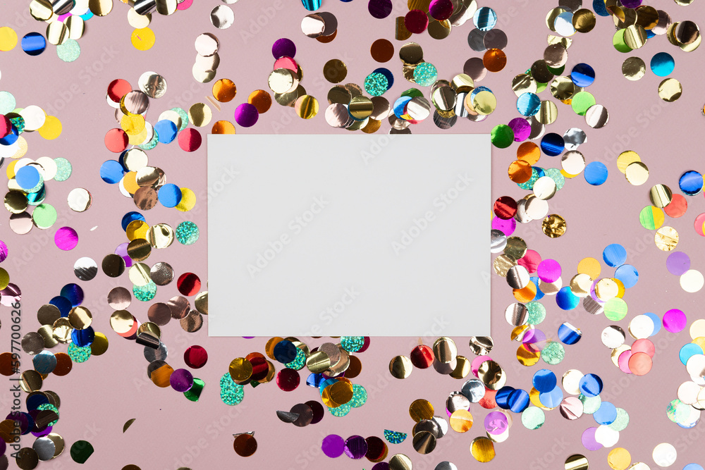 frame with confetti, card on a pale pink background with confetti