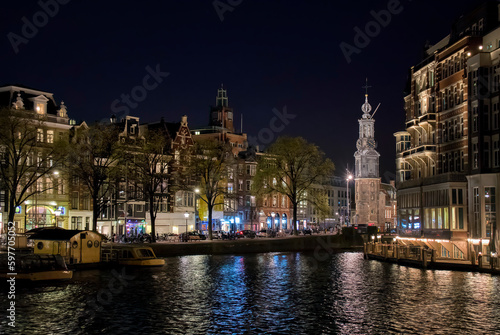 Nightshot of Buildings along the Amstel River in Amsterdam, Holland, with Munttoren