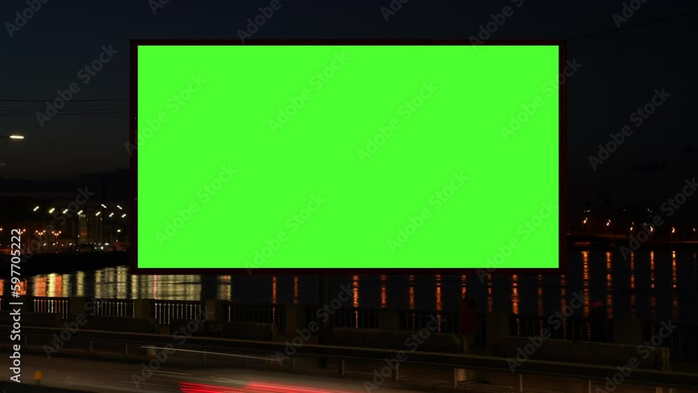 Timelapse of green screen billboard with night traffic. lightbox with chroma key on city street at night . reflection of streetlights on water. Commercial public information and advertising marketing Timelapse of green screen billboard with night traffic. lightbox with chroma key on city street at night . reflection of streetlights on water. Commercial public information and advertising marketing