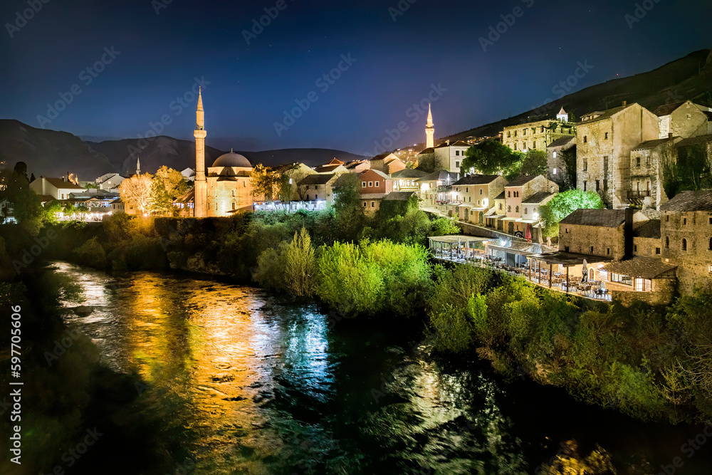 Night Shot from the Famous Old Bridge (Stari Most) Crossing the River Neretva in Mostar, Bosnia and Herzegovina, with the Koski Mehmed Pasha Mosque