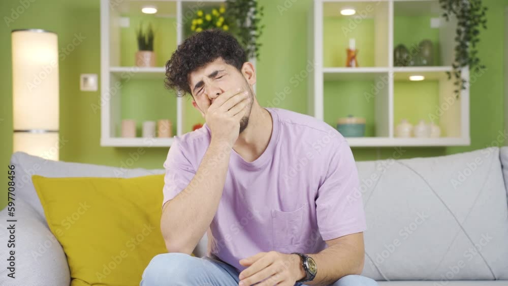 Sleepy young man at home yawning. Sleepy young man at home yawning.